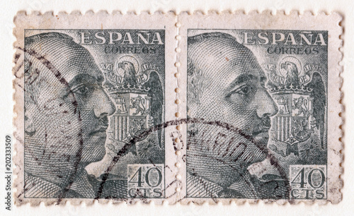 A pair of old blue vintage postage stamps with an image of general franco and the spanish eagle symbol photo