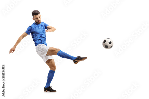Soccer player kicking a football