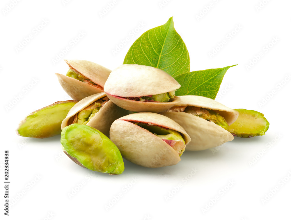 Pistachios with leaves on white background