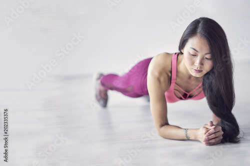 Sporty Asian women exercise indoor at home she is acted "push up". finished jogging