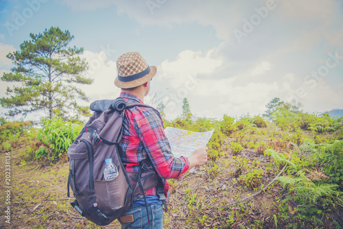 Young Man Traveler with backpack relaxing outdoor with rocky mountains on background Summer vacations and Lifestyle hiking concept © EKKAPON