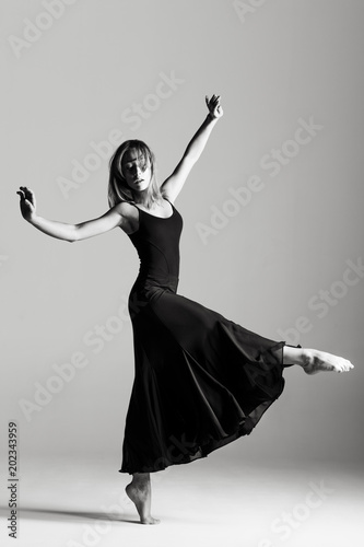 Young beautiful ballerina is posing in studio