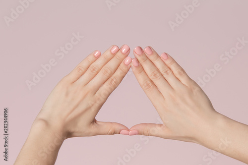 Woman fingers with pink nails