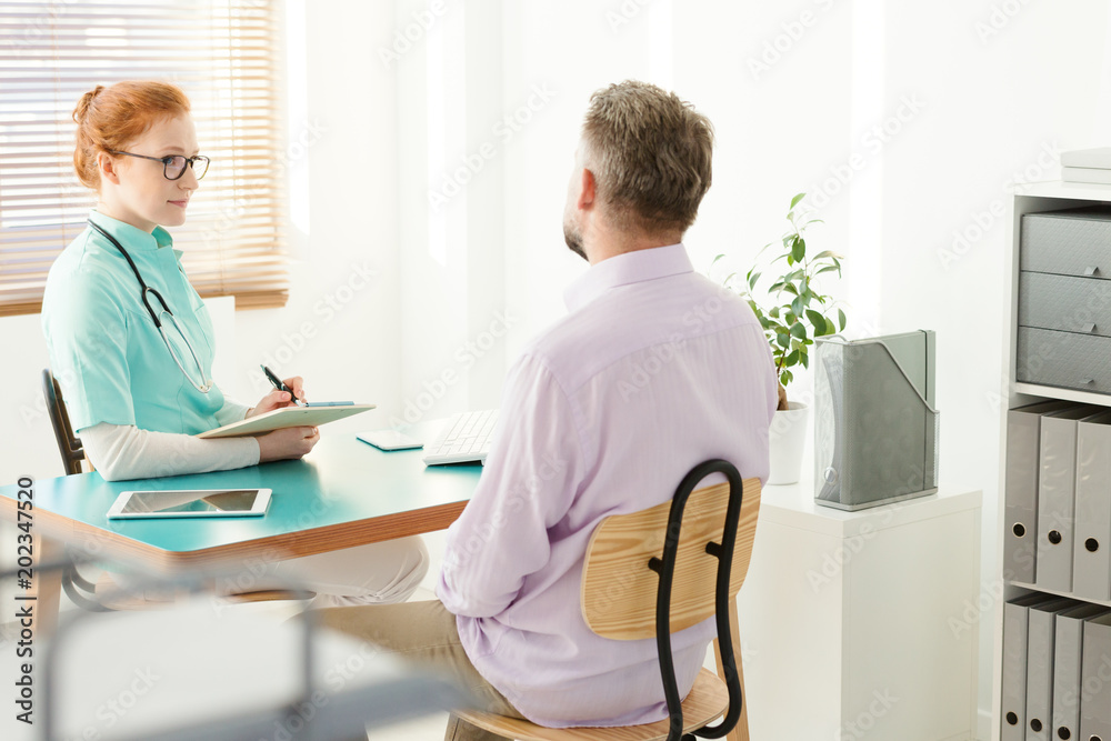 Sick man talking with urologist Sick man talking with urologist