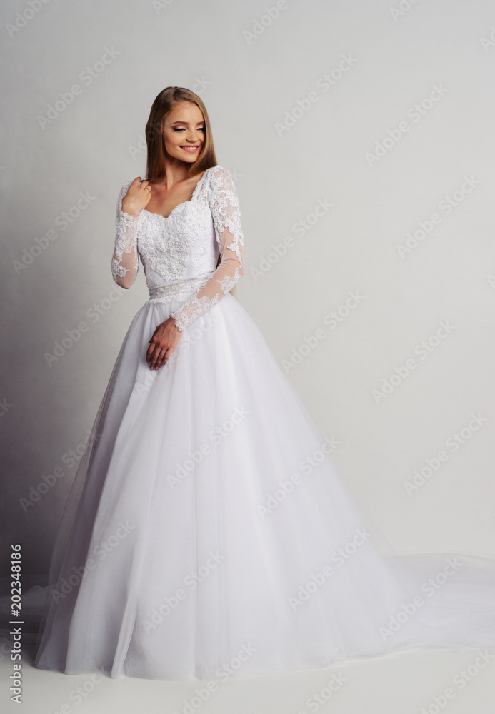 Beautiful bride in wedding dress, white background