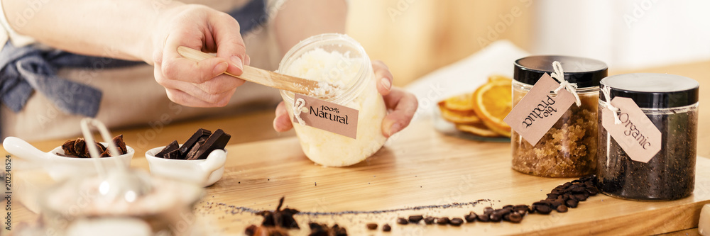 Person mixing natural coconut mass - obrazy, fototapety, plakaty 