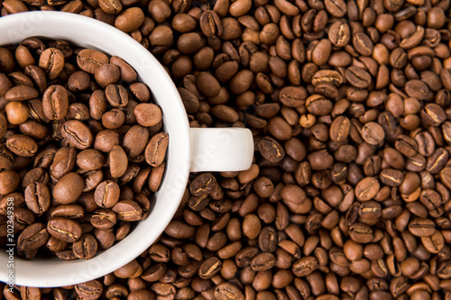Coffee beans and white cup for coffee top view