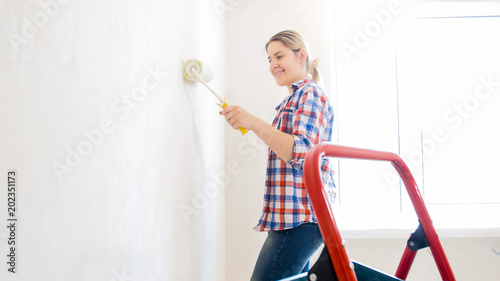 Portrait of smiling young woman doing renovation at new apartment