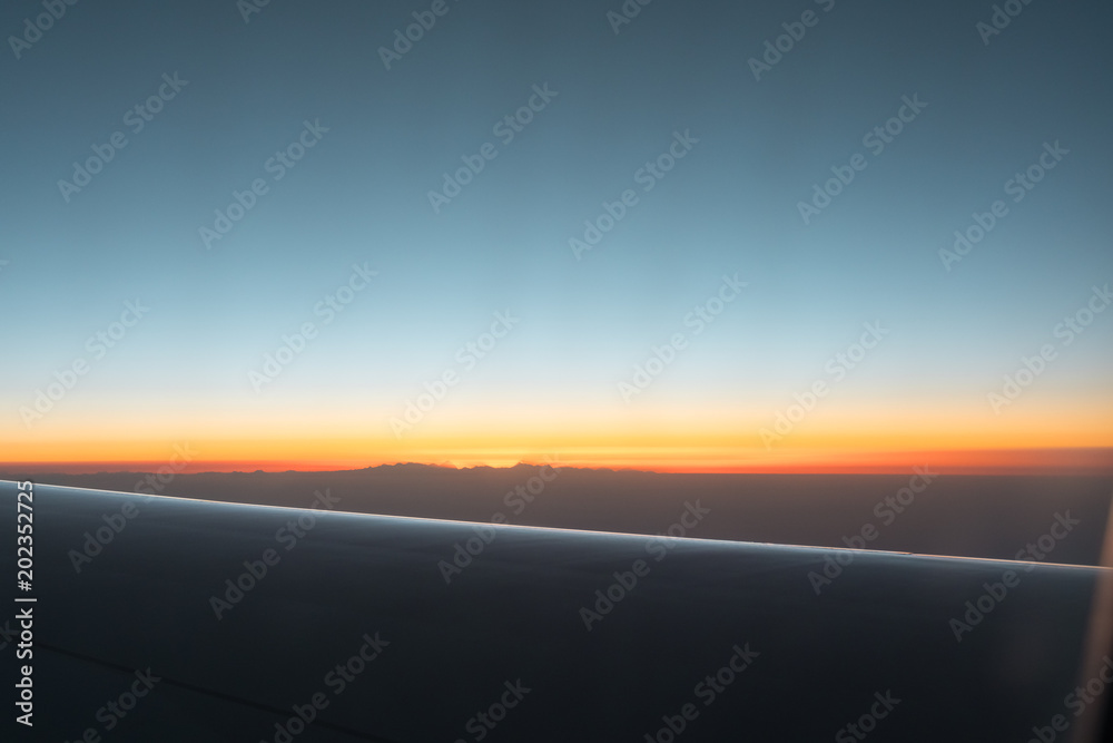 sunrise in the himalayas mountains from the airplane window.