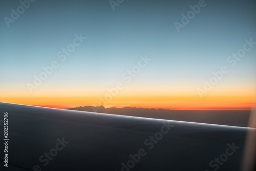 sunrise in the himalayas mountains from the airplane window.
