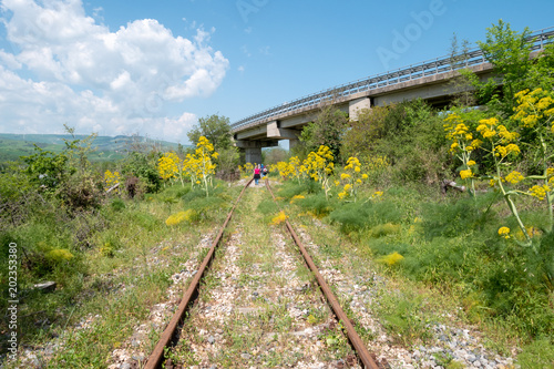 walking along abandoned railway track in Irpinia, Italy