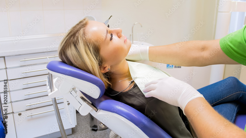 Closeup image of dentist putting tissue on his patient Closeup image of dentist putting tissue on his patient