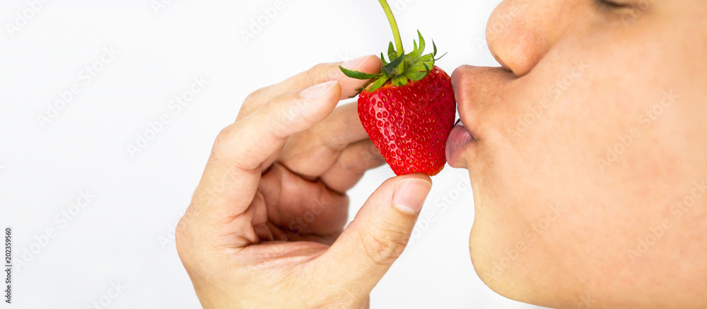 Obraz premium Man kissing strawberry and hand holding, white background