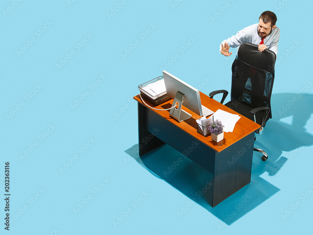 Shot from above of a stylish business man working on a laptop. Shot from above of a stylish business man working on a laptop.