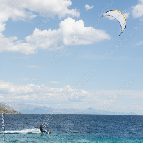 Adult male is trained at kitesurfing at Adriatic sea in the summer