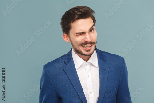 Funny businessman wink and flirt at camera © khosrork