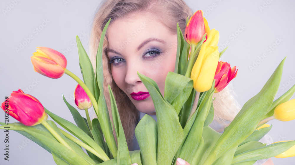 Pretty woman with red yellow tulips bunch Pretty woman with red yellow tulips bunch