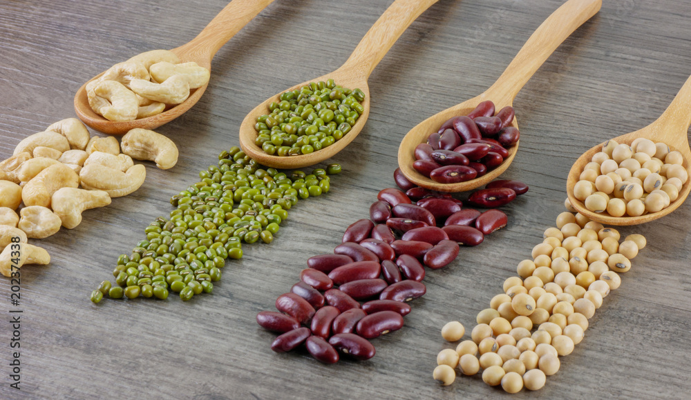 Variety of beans included cashews,green beans,red beans and soy beans close up on wooden table Food,ingredients,nature concept Variety of beans included cashews,green beans,red beans and soy beans close up on wooden table Food,ingredients,nature concept