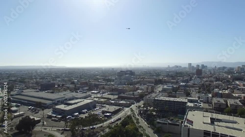 Drone shot of helicopter flying over mid city Los Angeles photo