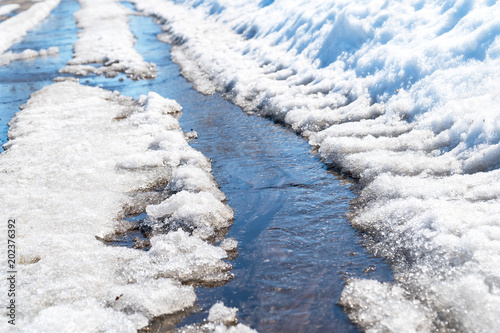 Spring creek flows through the asphalt photo