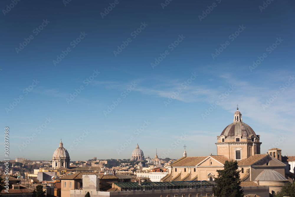 Church domes and rooftops of old buildings in Rome