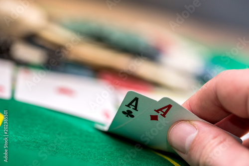 Woman looking gambling poker card in casino