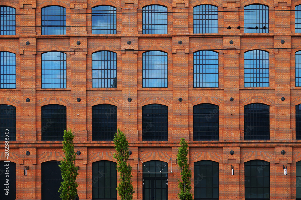 A red brick wall, a revitalized building of a former factory.