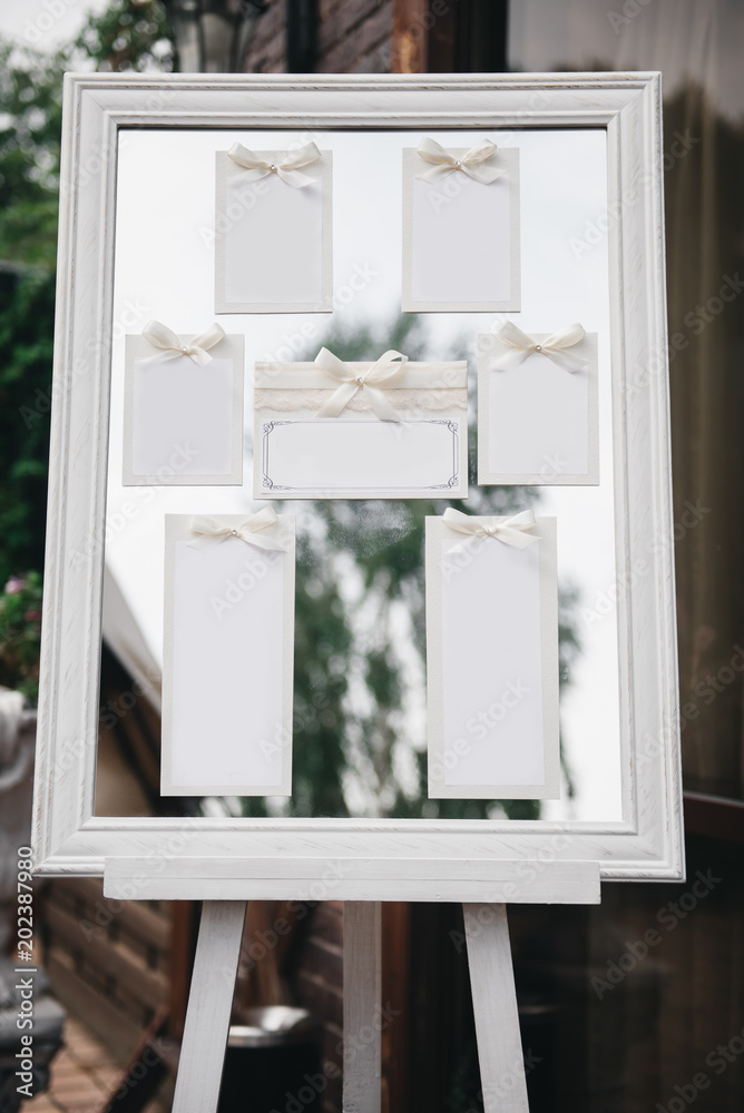 Wedding Photography: Classic Seating Chart on a White Wooden Frame, copy space