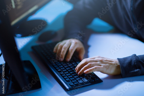 Fototapeta Naklejka Na Ścianę i Meble -  cybercrime, hacking and technology concept - hacker hands typing on computer keyboard