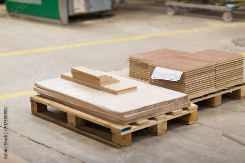 production  manufacture and woodworking industry concept - wooden boards and chipboards storing at furniture factory