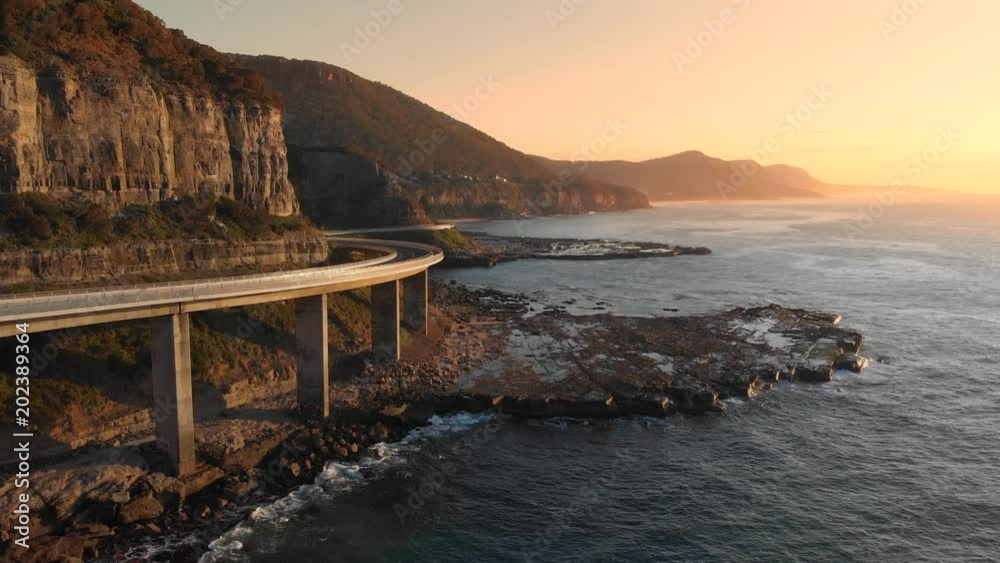 Aerial footage Australia sea cliff bridge coastal drive sunrise coastal seascape