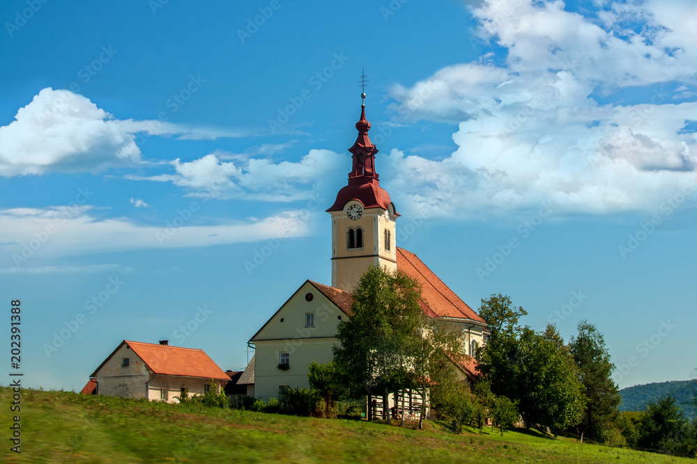 Superb views of the European landscape with road leading to the Church on a Sunny summer day Superb views of the European landscape with road leading to the Church on a Sunny summer day