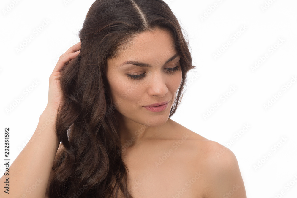 Young brunette female looking aside and touching brown hair. Isolated on white background. Mid age woman over 35 years old beauty concept. Young brunette female looking aside and touching brown hair. Isolated on white background. Mid age woman over 35 years old beauty concept.