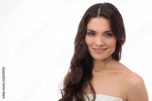 Smiling brunette beauty posing on camera. Having perfect skin. Mid age woman over 35 years old beauty concept.