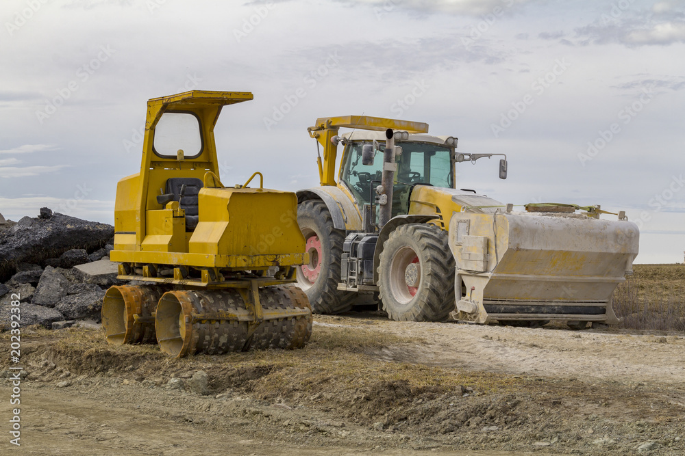 loader and road roller at a construction site