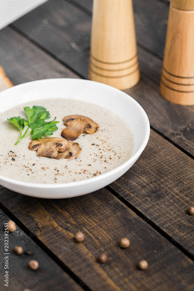 A bowl of mushroom soup cream on the table A bowl of mushroom soup cream on the table