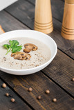 A bowl of mushroom soup cream on the table