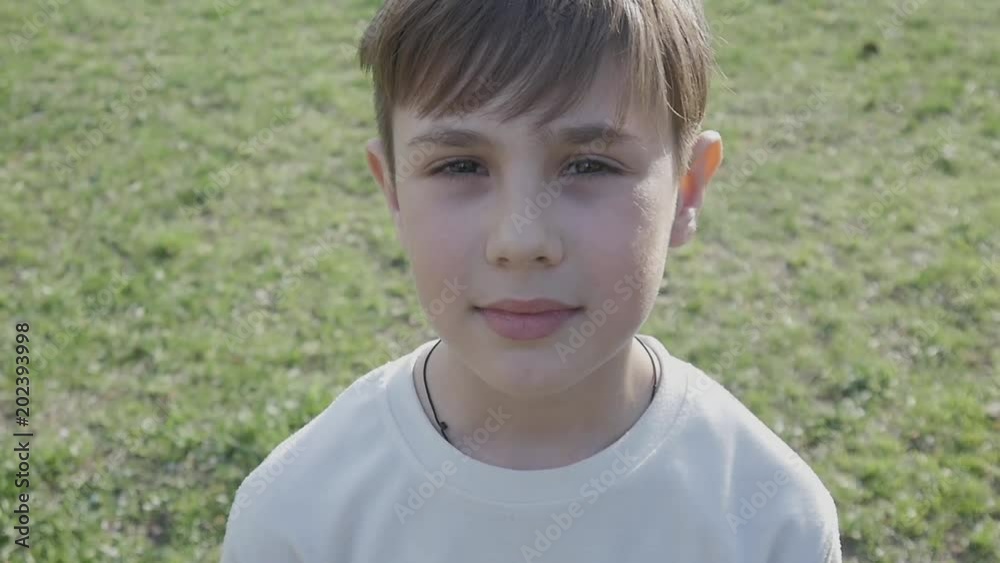 Close up portrait half-face of a boy 10 years old on a background of greenery in spring or summer. Close up portrait half-face of a boy 10 years old on a background of greenery in spring or summer.