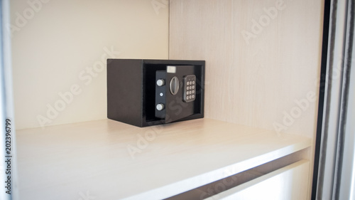 Closeup image of small open safe box in hotel room