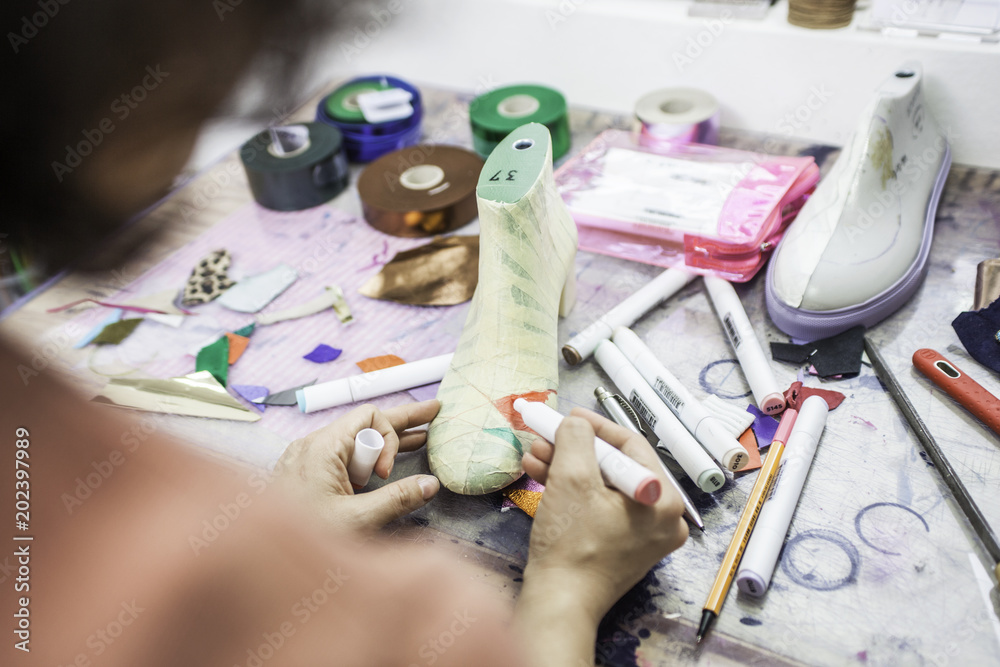 Fotografie Woman designer making handmade shoes in her workshop