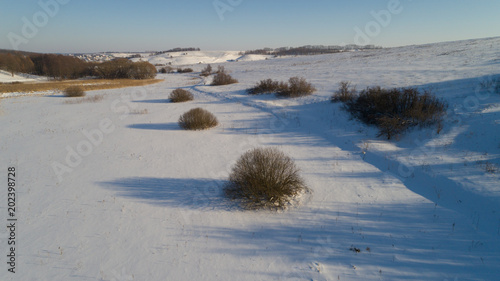 Aerial view of russian winter landscape with long shadows