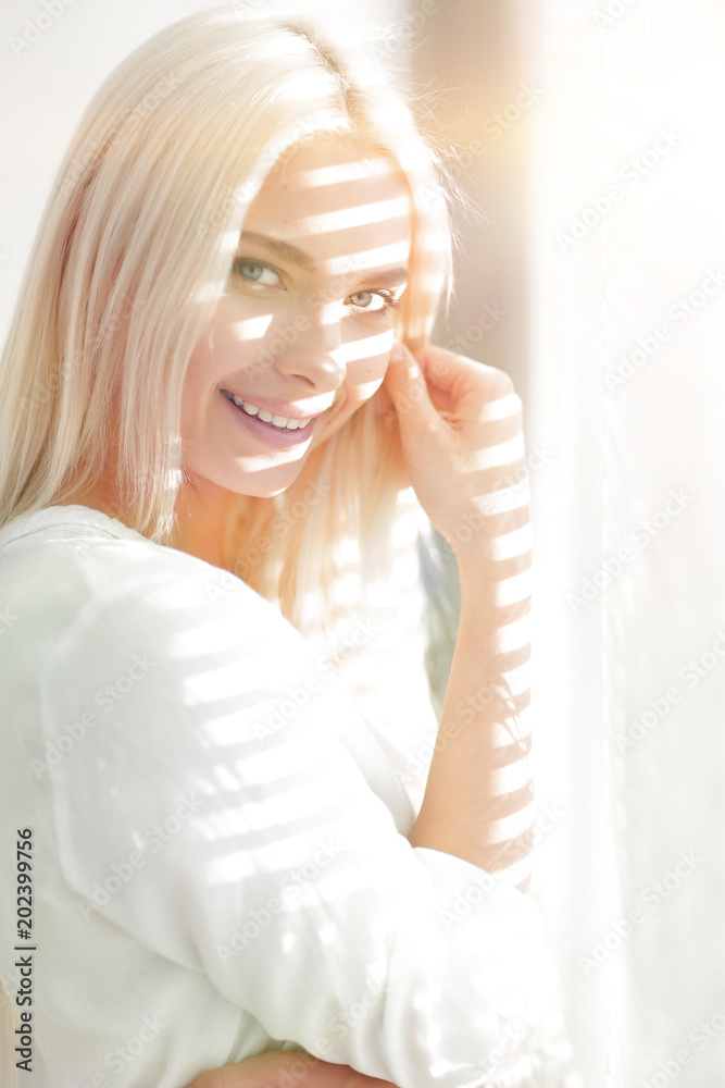 close-up of a young business woman standing near a window close-up of a young business woman standing near a window