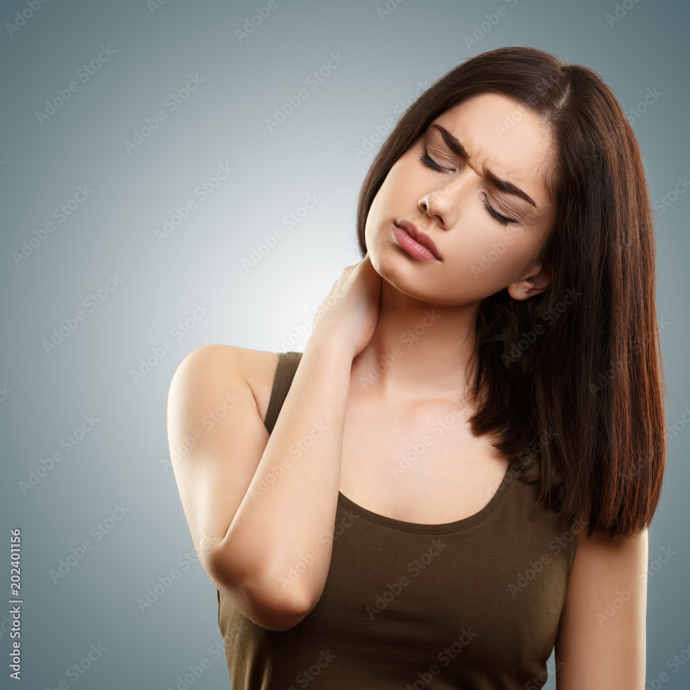 Young isolated woman suffering from neck pain Young isolated woman suffering from neck pain