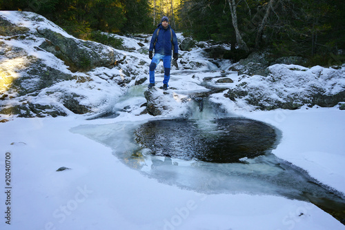 A man standing in the middle of a small river.