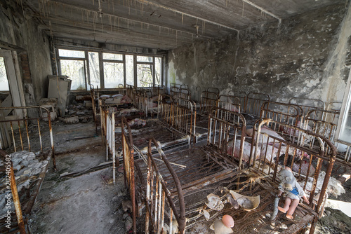 Abandoned kindergarten in Chernobyl Exclusion Zone. Lost toys, A broken doll. Atmosphere of fear and loneliness. Ukraine, ghost town Pripyat.