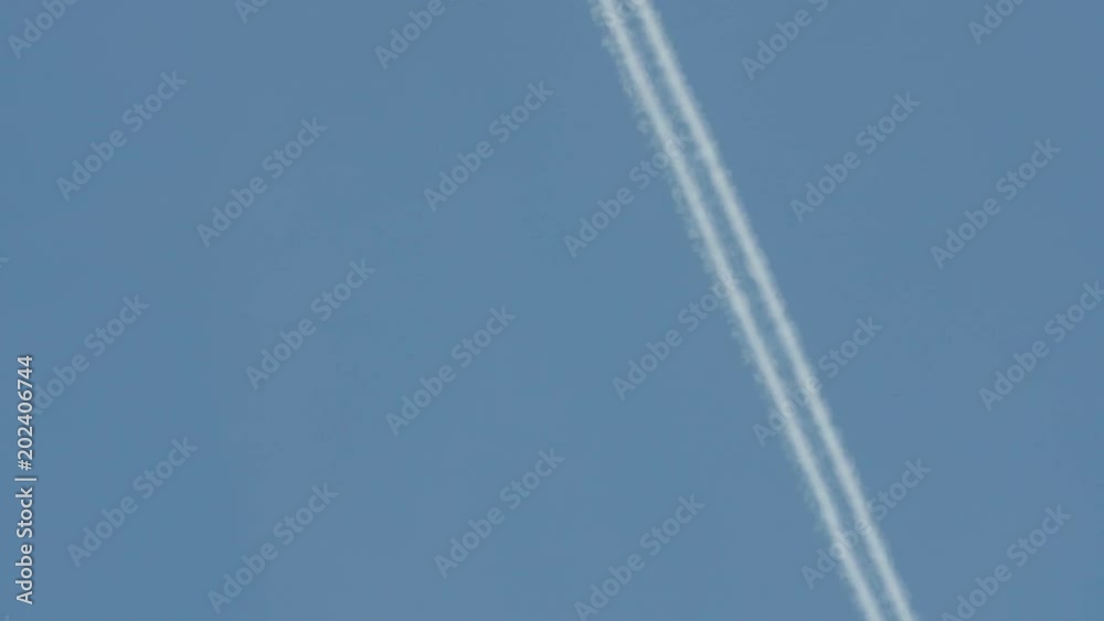 Jet plane flying high in the sky, leaving a white trail.