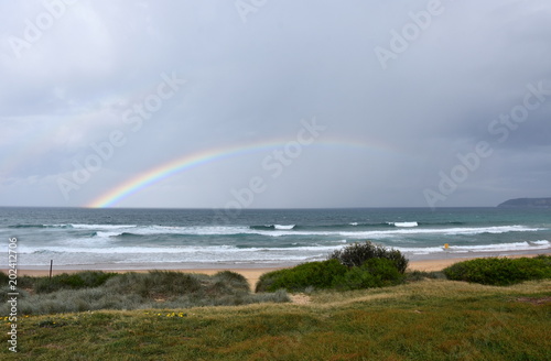 Rainbow over the Tasman sea. Seascape with beautiful multicoloured rainbow over the sea and Curl Curl beach, Australia.