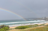 Rainbow over the Tasman sea. Seascape with beautiful multicoloured rainbow over the sea and Curl Curl beach, Australia.