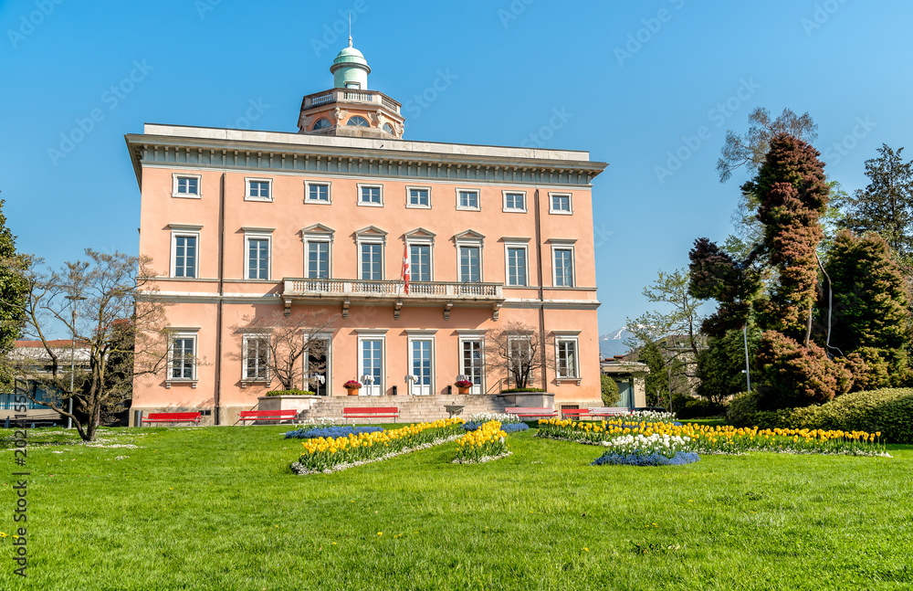 View of Villa Ciani with colorful tulips foreground in the public city park of Lugano, Switzerland