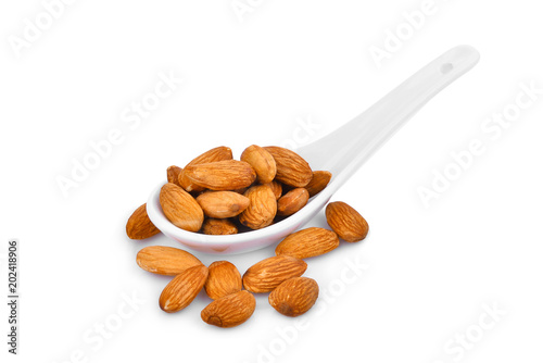 almonds seeds in the white spoon isolated on white background